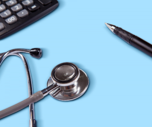 Stethescope, pen, and calculator on table.