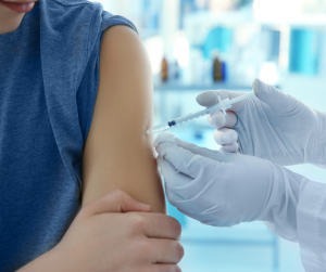 Doctor giving patient shot in the arm.