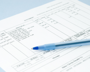 Pen laying on top of medical bill.