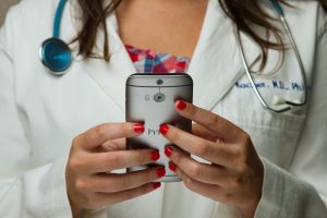 Doctor looking at cell phone.